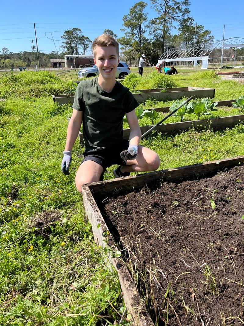 Student helping out at a community garden